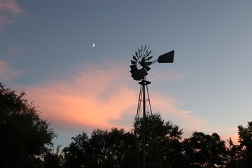 windmill at sunset with moon