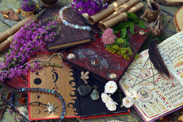 Mystic still life with magic book of spells, crystals and witchy ritual objects on old table....