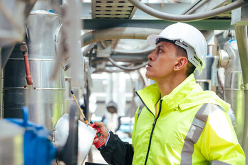 technician carefully inspecting a section of pipeline during a construction project, emphasizing safety and precision in infrastructure development.