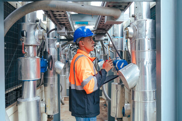technician carefully inspecting a section of pipeline during a construction project, emphasizing...
