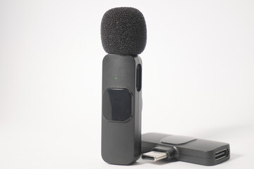 close up o mini black wireless microphone on white background isolated