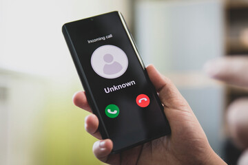 Unknown number calling in the middle of the morning. Phone call from stranger. Person holding...