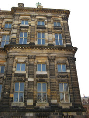  Royal Palace on Dam Square reveals its stately, symmetrical design with rows of tall arched windows. 