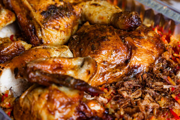 closeup of roasted chicken with spices in chicken kabsah and mandi rice