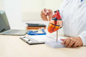 A female doctor works at a desk in the hospital,discussing heart diseases such as coronary artery...