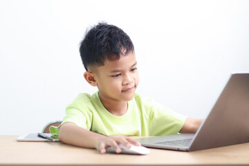 A Happy little asian boy studying online learning class with online video call zoom teacher at home. E-learning or Home schooling education concept.