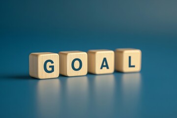 Obraz premium Wooden cubes spelling the word GOAL, on a blue background
