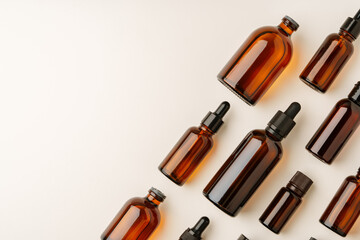 Various Amber Glass Containers for Essential Oils and Skin Care Products Displayed on Light Background
