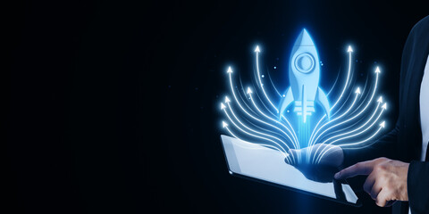 Close up of man hand using tablet with creative glowing rocket spaceship and arrows on dark blue background with mock up place. Start up, launch, social media, network and connection concept.