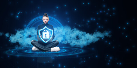 Attractive young woman sitting on floor with crossed legs and using laptop with glowing padlock and...