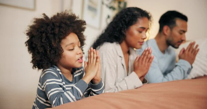 Family, child and hands for praying on bed together, worship and talking to God for praise or love. Parents, son and trust in jesus christ for peace or support, hope and gratitude for spirituality