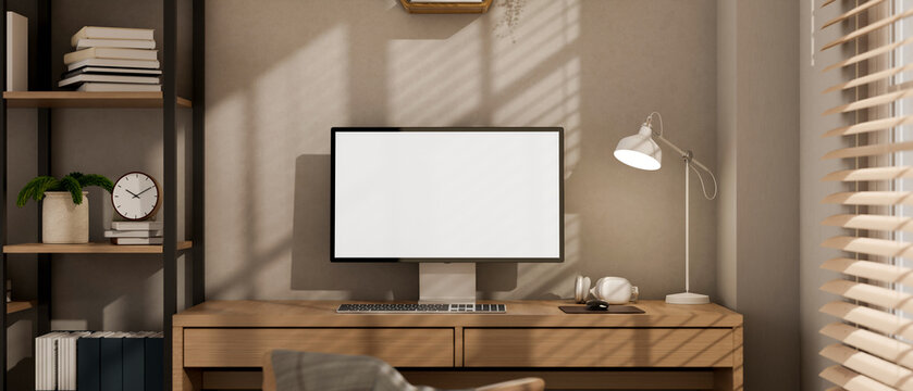 A contemporary minimalist home office workspace features a computer on a wooden desk.