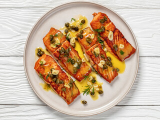 salmon piccata with lemon caper sauce on plate