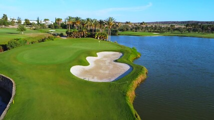Coach teaching a girl and her brother to play golf in summer in a luxury course
