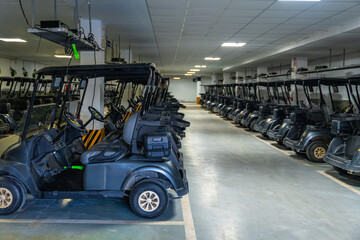 Line of golf carts parked in a garage