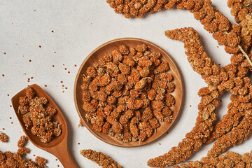 top view flat lay red millet spray food for pet and bird on white background in wood plate with copy space
