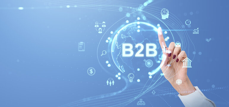 A businesswoman's hand interacts with a B2B digital interface. The interface includes various business icons and a world map on a blue background. Concept of business-to-business technology