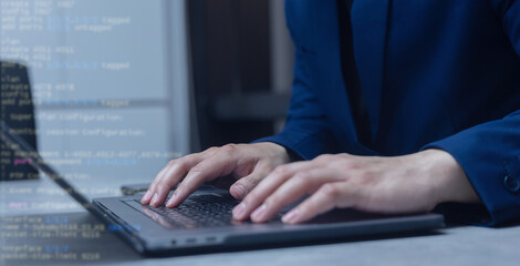 specialist engineer man hand type configuration code on at laptop for check software function for fix bug and defect of security system in dark datacenter room for protection and technology concept