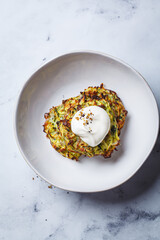 Zucchini pancakes with sour cream.