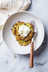 Zucchini pancakes with sour cream.