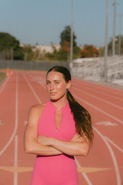 Female track athlete standing at starting line