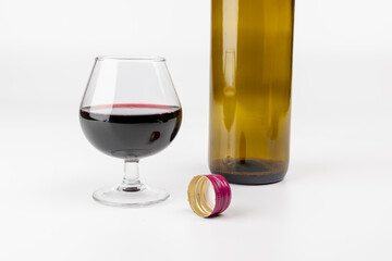 Horizontal Wine Still Life with Red Wine Glass, Bottle, and Cork on White Background