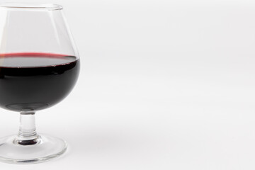 Red Wine Glass on Left Side with White Background and Horizontal Composition
