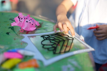 Mother and daughter doing colorful crafts in outdoor garden