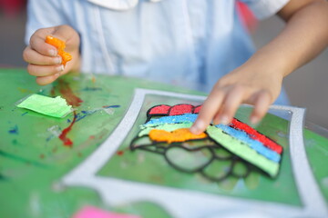 Mother and daughter doing colorful crafts in outdoor garden