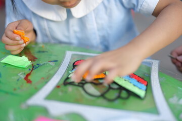 Mother and daughter doing colorful crafts in outdoor garden