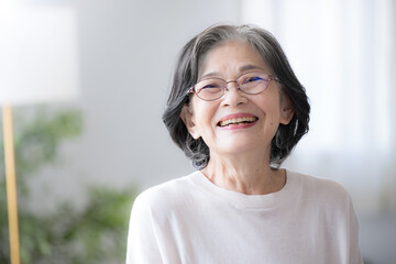 Smiling senior woman Close-up of a healthy elderly woman laughing hysterically in her room