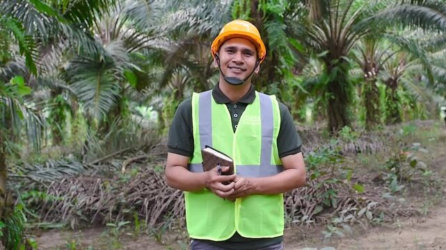 A Field Worker smiling and showing his thumb up at the camera wearing a safety worker