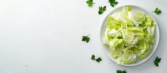 Obraz premium A top down view of fresh sliced cabbage on a white dish against a white backdrop with a spacious copy space image Fresh veggie salad prep health perks and a flat lay arrangement