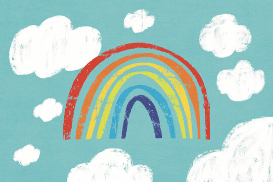 Rainbow with clouds against blue background