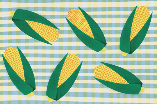 Paper corn cobs on checkered tablecloth