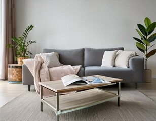 Obraz premium Interior of cozy living room with grey sofa and coffee table near white wall