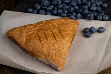 close-up of a blueberry stuffed bun with blueberries