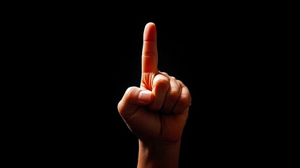 A hand with a raised finger against a dark background, symbolizing importance, attention, or a call to listen. High Quality.
