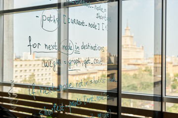 Background image of text and formulas on glass wall in modern school or college, no people, copy space