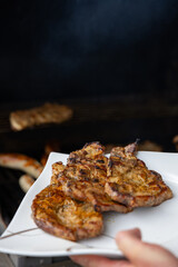 A close-up of a barbecue grill loaded with grilled sausages and seasoned steaks, showcasing the deliciously charred and juicy meat. Perfect for a summer cookout or a weekend barbecue feast