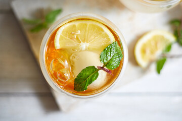 Homemade iced peach tea with lemon