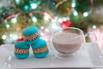 Christmas tree Christmas food sweets dessert Colorful French macarons isolated on white background with glass cup of hot cocoa