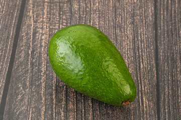 Ripe green avocado over background