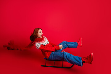 Fototapeta premium Full size photo of young pretty woman ride sledge new year isolated on red color background