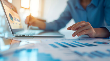 Businesswoman analyzing financial data on laptop