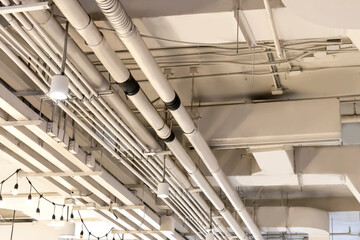 Metal pipes or galvanized pipes for electrical wiring painted white. Air conditioning pipes used in large areas, electrical systems, air conditioning systems.