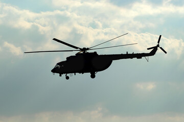 Fototapeta premium Multi-purpose russian transport and assault helicopter silhouette aviation rotary-wing machine receiving a guided weapons system