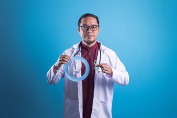 Asian Doctor Holding Light Blue Ribbon, a Symbol For Diabetes Awareness Month