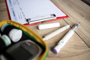 Daily blood sugar log testing and sample blood in tube and syringe in laboratory. Blood sugar control concept.