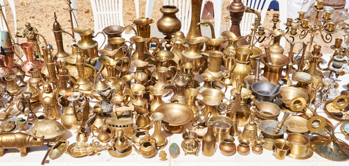 Antique brass and bronze utensils at flea market